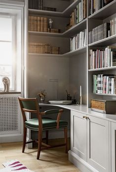 a room with bookshelves, desk and chair