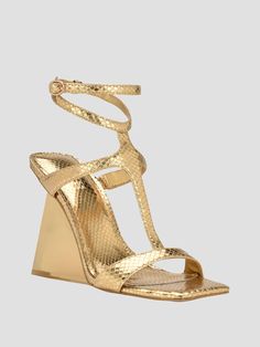 Showcase your style in these metallic heels featuring a T-strap vamp design with snakeskin texturing, open toe and unexpected sculptural wedge heel. Wedge Dress, Sandals Gold, Metallic Heels, Strap Wedge, Shoes Heels Wedges, Guess Shoes, Gold Snake, Dress Sandals, Wedge Sandal