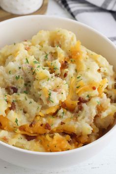 a white bowl filled with mashed potatoes on top of a table