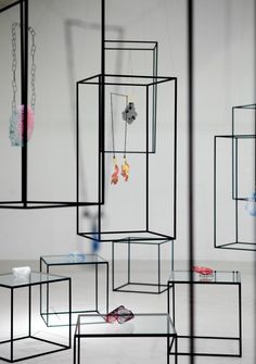 an artistic display with various jewelry hanging from it's sides