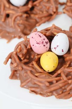 chocolate nests with candy eggs in the middle on a white plate, ready to be eaten