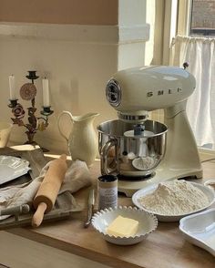 a kitchen counter topped with lots of different types of baking supplies and utensils