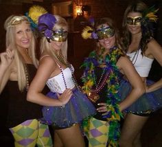 three women in costumes posing for a photo