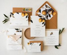 wedding stationery with oranges and greenery