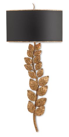 a gold leaf lamp with a black shade