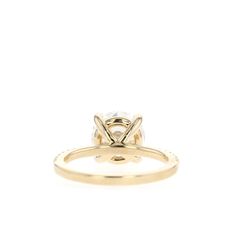 a yellow gold engagement ring with a round diamond in the center and two small diamonds on each side