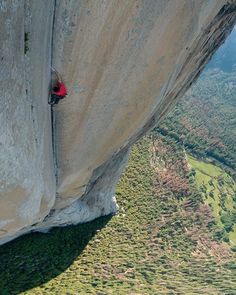 a man climbing up the side of a cliff