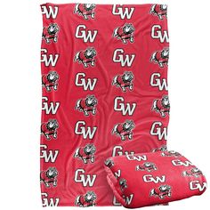 the northwest university blanket and pillow set is shown in red with white letters on it