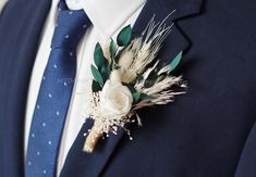 a man in a suit and tie with a boutonniere on his lapel