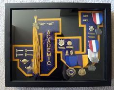 a shadow box with medals and ribbons in it