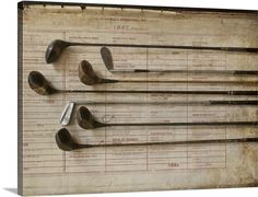 four golf clubs are hanging on the back of an old scoreboard with numbers and lines