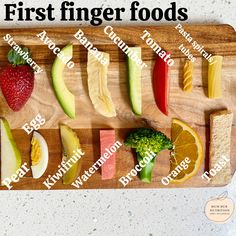 a wooden cutting board topped with different types of fruits and veggies on it