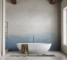 a large white bath tub sitting in a bathroom next to a painting on the wall