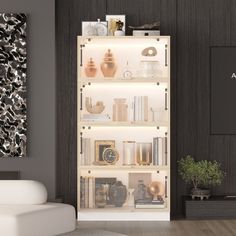 a white couch sitting in front of a book shelf filled with books and vases