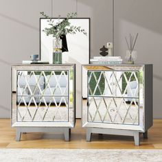 two mirrored nightstands with flowers and books on them