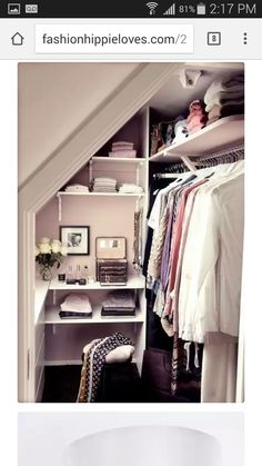 an image of a closet with clothes on shelves and other items in the closets