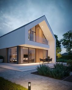 a modern house is lit up at night