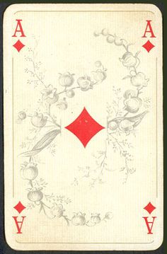 the back side of a playing card with red and white designs on it's sides