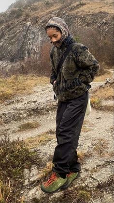 a man standing on top of a rocky hillside