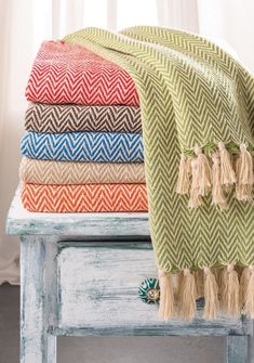 a stack of towels sitting on top of a wooden table