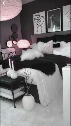 a black and white bedroom with pink accents