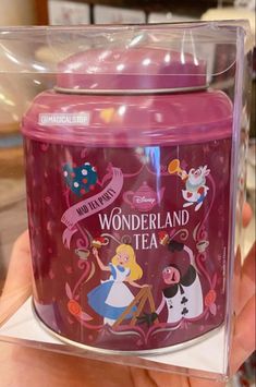 there is a plastic container with an image of alice and wonderland tea on the lid