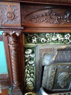 an old fireplace with ornate carvings on the mantle