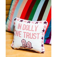 a pillow that says in dolly we trust