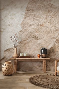 a wooden table sitting on top of a hard wood floor next to a vase filled with flowers