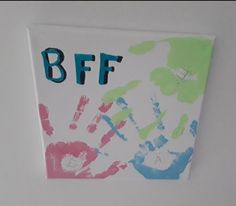 a child's handprint is displayed on the wall