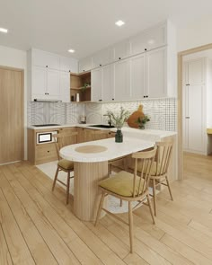 a large kitchen with wooden floors and white cabinetry, along with a center island