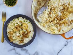 two bowls of macaroni and cheese on a marble table