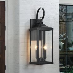 an outdoor wall light with three lights on it's side and the door open