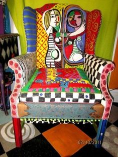 a colorful chair sitting on top of a black and white checkered floor next to a green wall