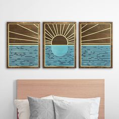 two paintings on the wall above a bed