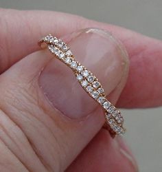 a close up of a person's finger with a ring on top of it