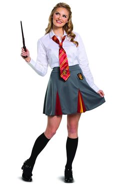 a woman in a skirt and tie holding a wand