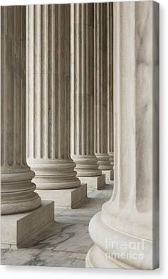 the columns are lined up in an old style building with marble flooring and walls