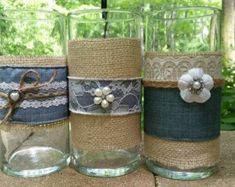 three glass jars with burlocks and lace on them