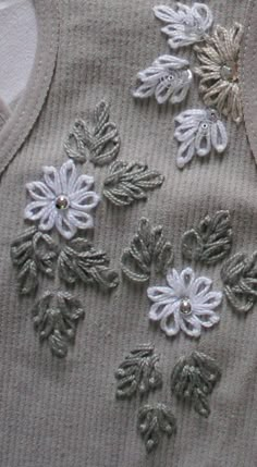 some white and grey flowers on a gray shirt