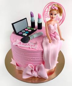 a birthday cake with a barbie doll on top