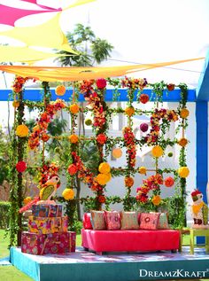 an outdoor seating area decorated with flowers and decorations