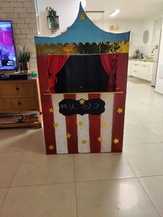 a cardboard box that is decorated like a circus tent