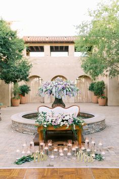 an outdoor ceremony setup with flowers and candles