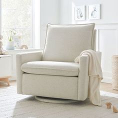 a living room with a white chair and rug