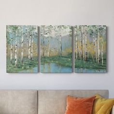 three paintings hanging on the wall above a couch