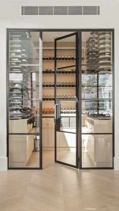 the inside of a wine cellar with glass doors