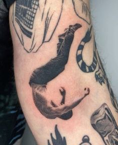 a man's arm with tattoos on it