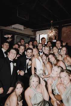 a group of people in formal wear posing for a photo