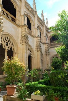 an old building with many windows and plants